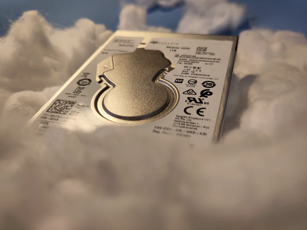 Image of 2.5" hard drive seated in cotton clouds against a blue background