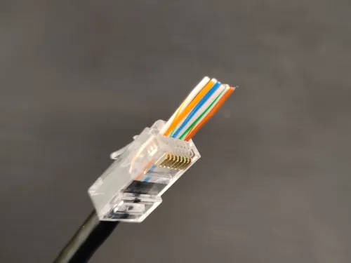 Image of an Ethernet cable in the process of being made