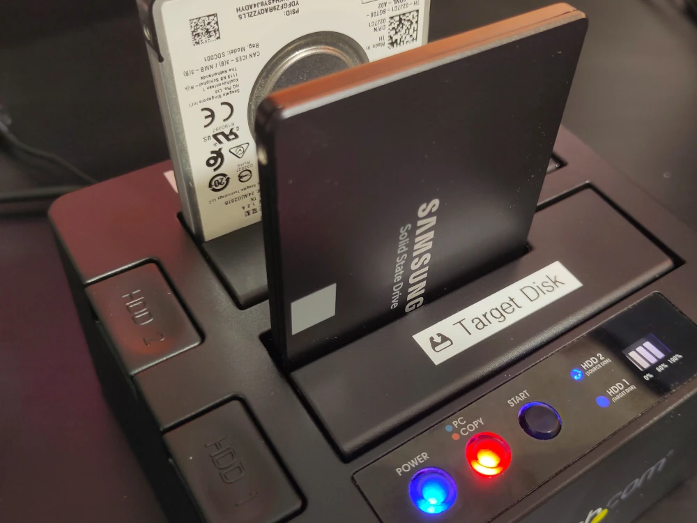 Image of a two and a half inch hard drive and a two and a half inch solid state drive in an external dock